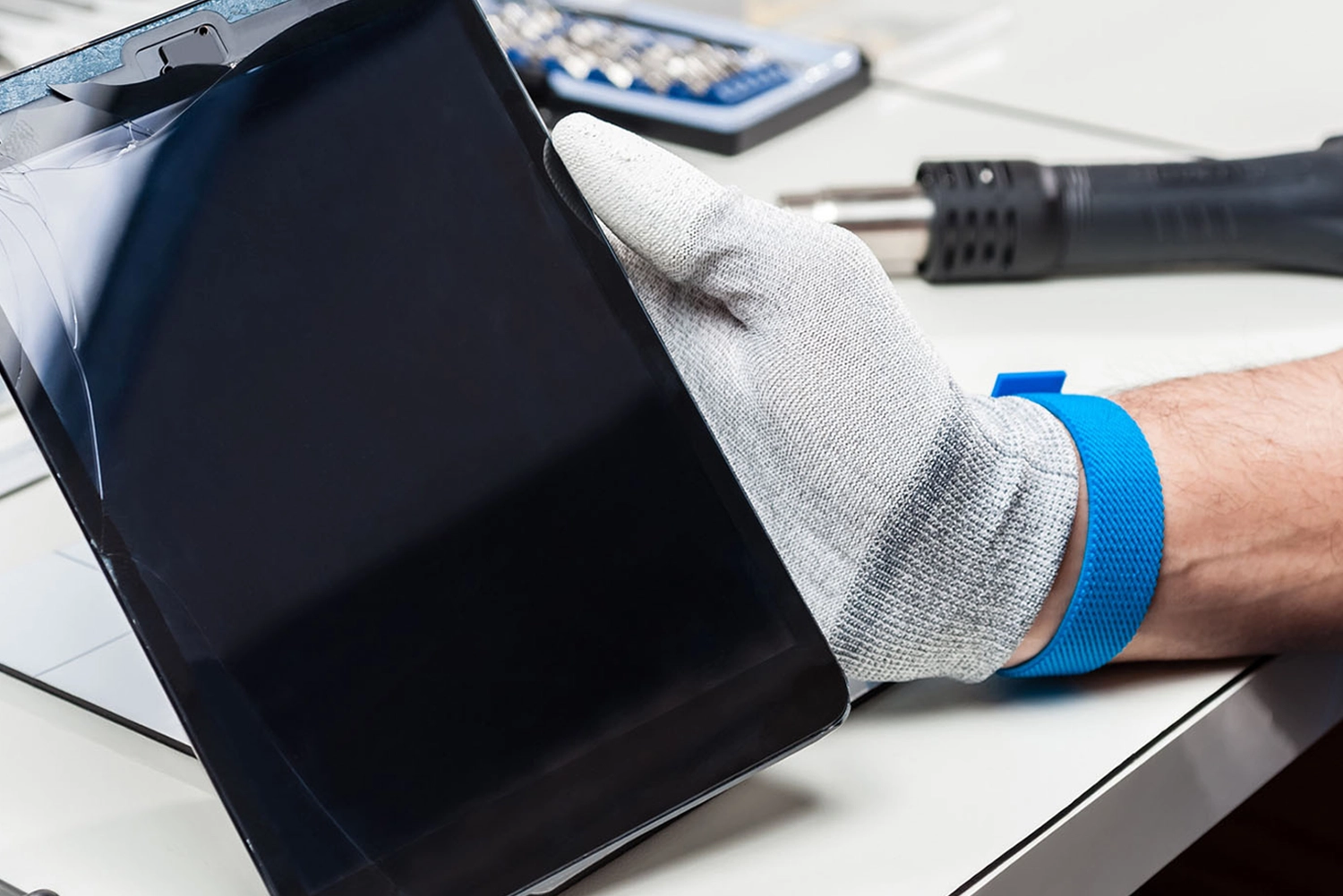 Technician repairing a cracked school iPad screen